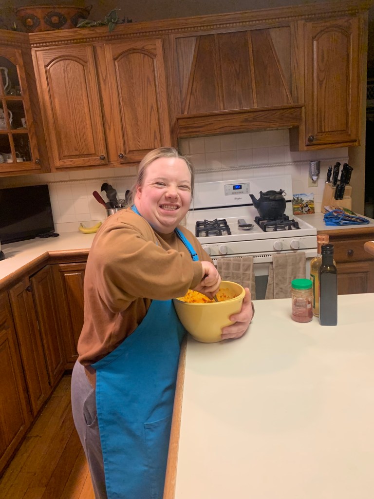 Image description: I mix the ingredients for the firecracker sauce in a bowl while looking at the camera