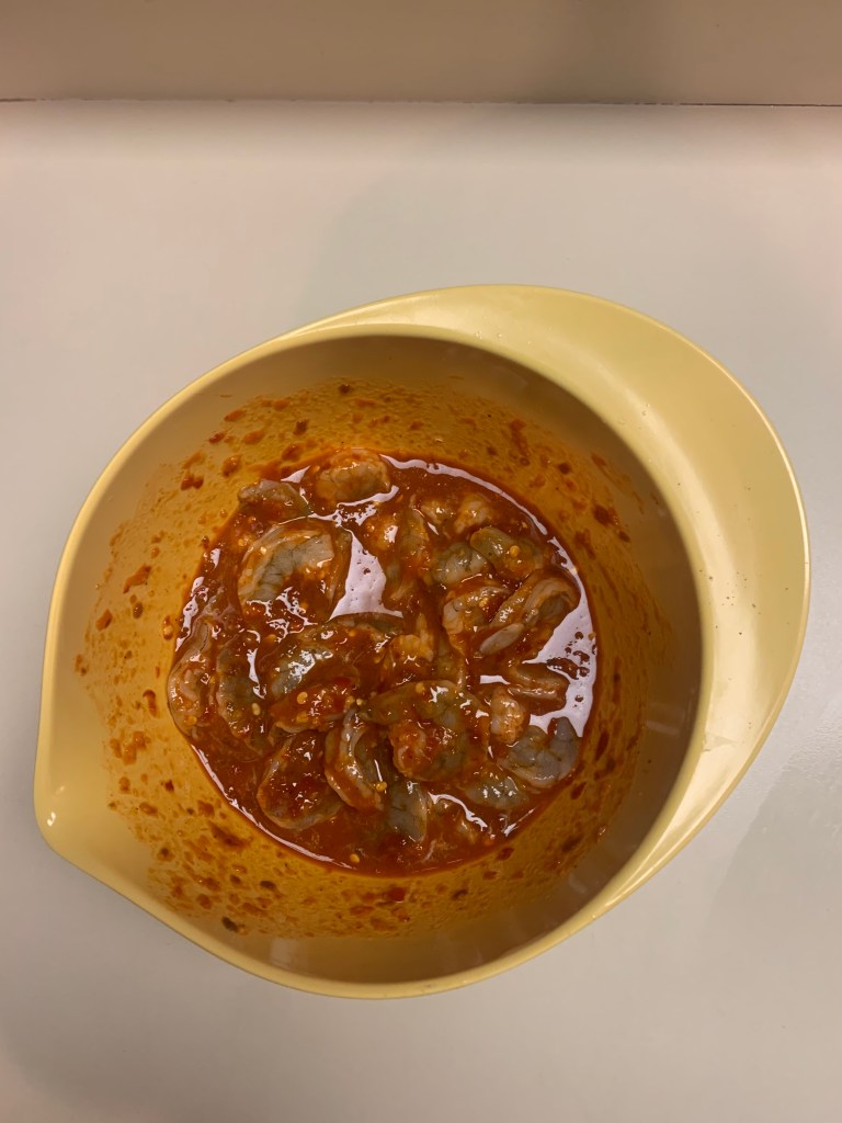 image description: shrimp mixed with the firecracker sauce in a bowl before I cooked the shrimp.