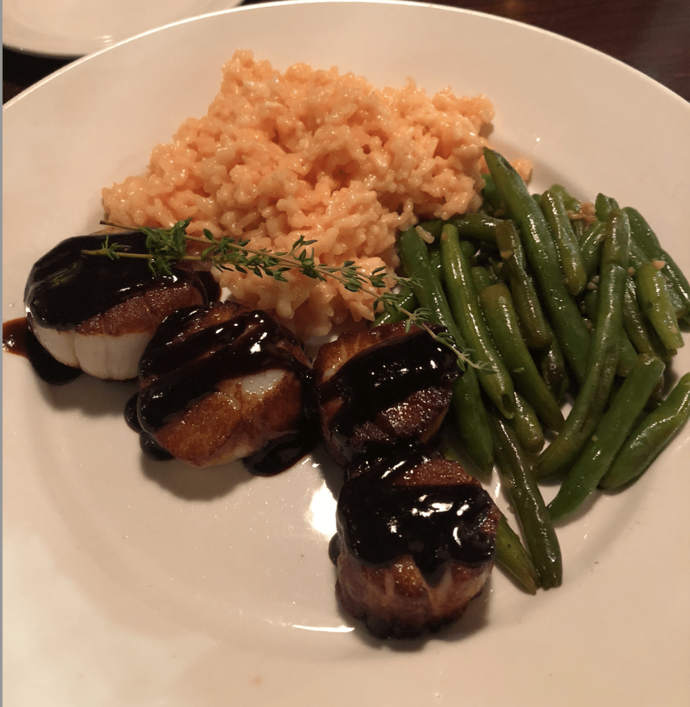 image description: pan seared jumpo sea scallops, green beans, and saffron risotto